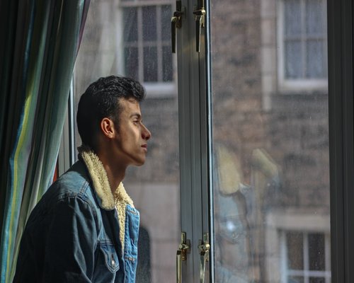 Person taking a short break looking out the window during a regular workday