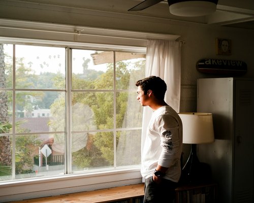 Person taking a short break looking out the window during a regular workday